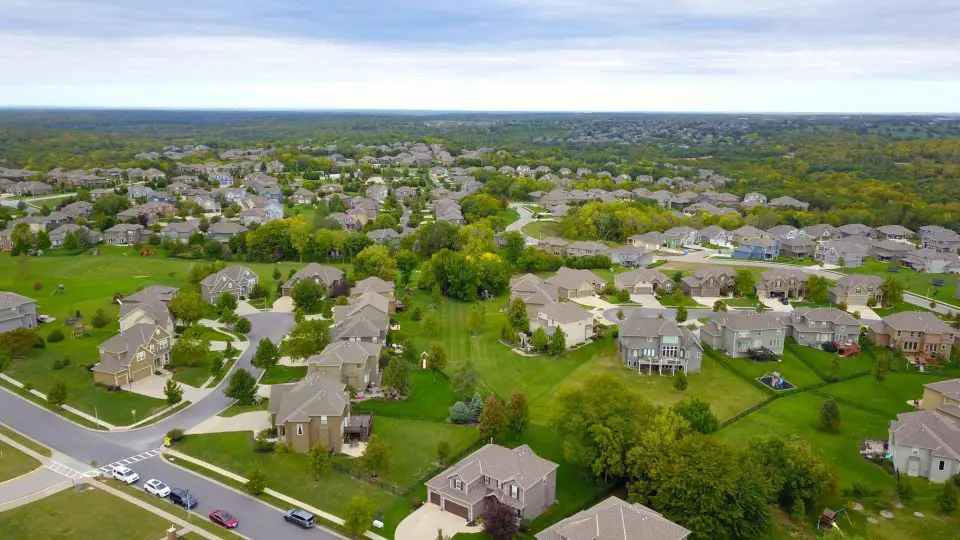 Aerial view of suburban neighbourhood with green spaces.