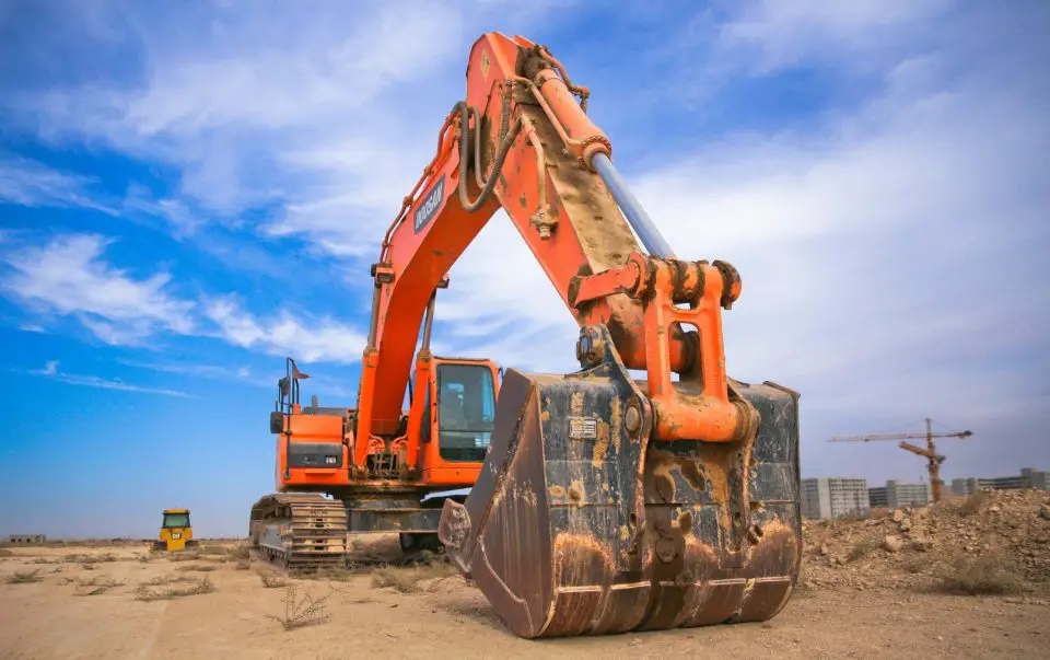 Large orange excavator at construction site