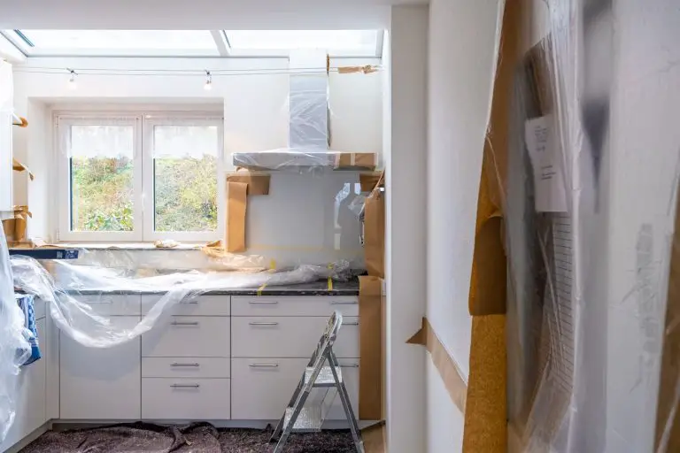 Kitchen under renovation with protective coverings