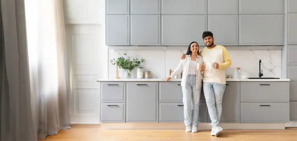 Indian couple standing in front of an IKEA kitchen