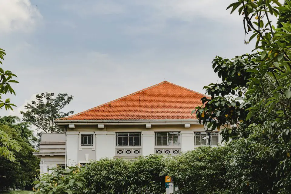 Orange roof house surrounded by trees.