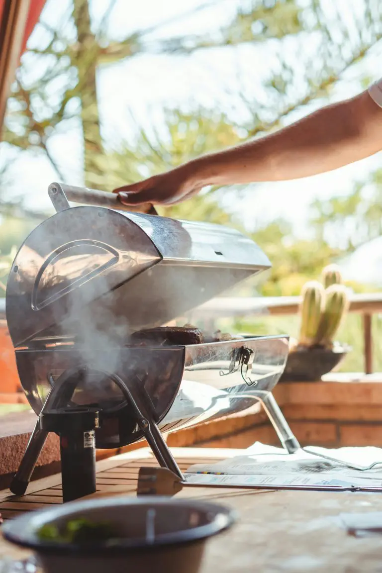 Person grilling outdoors on a sunny day.