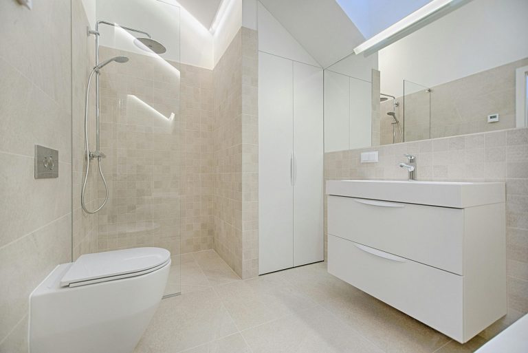 Modern, minimalistic bathroom with shower and sink.