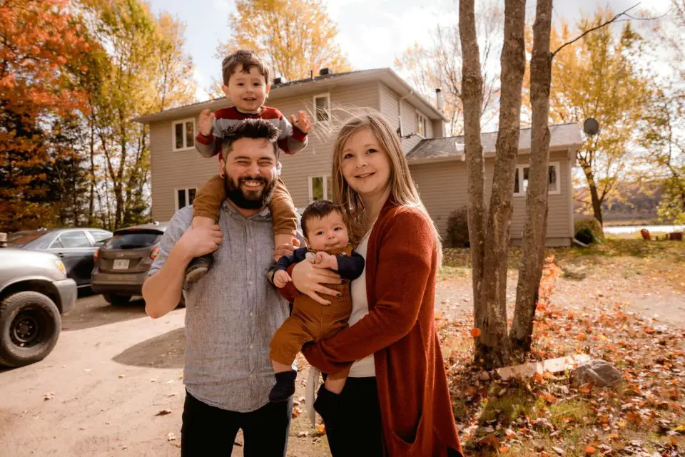 family in front of house