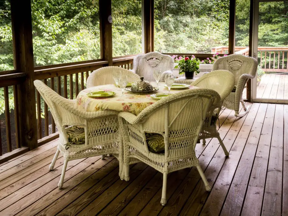 Wicker patio furniture on a screened porch