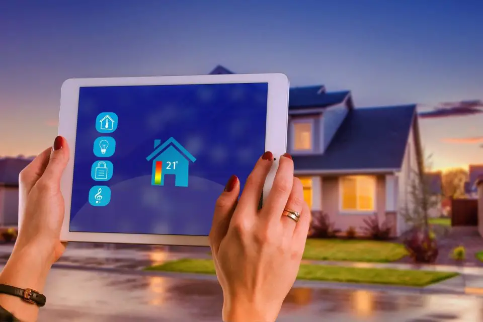 Tablet controlling smart home features outside house.