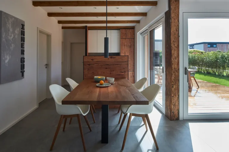 Modern dining room with wooden table and chairs.