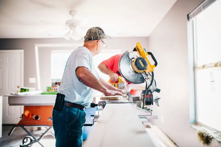 Carpenters using power tools indoors