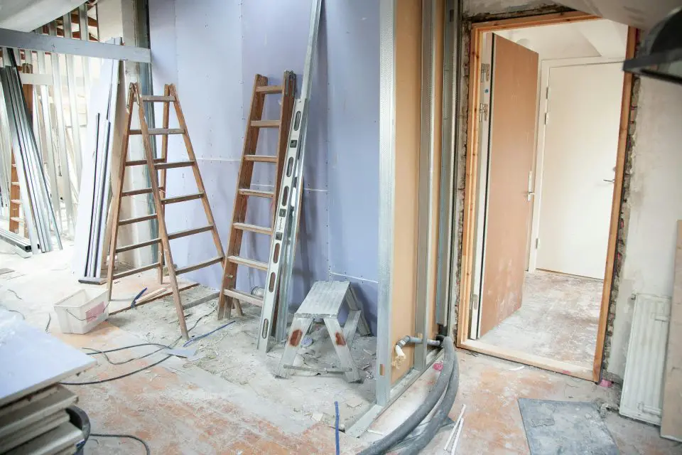 Home renovation with ladders and tools present.