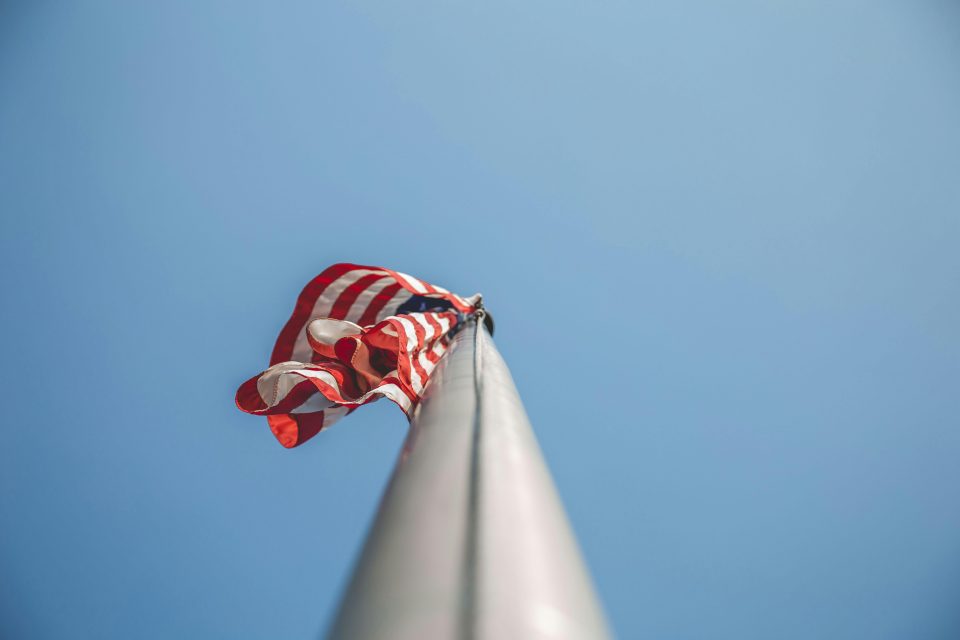 American flag on pole against clear sky