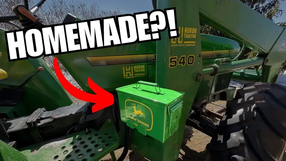 Green metal box on farm tractor with arrow