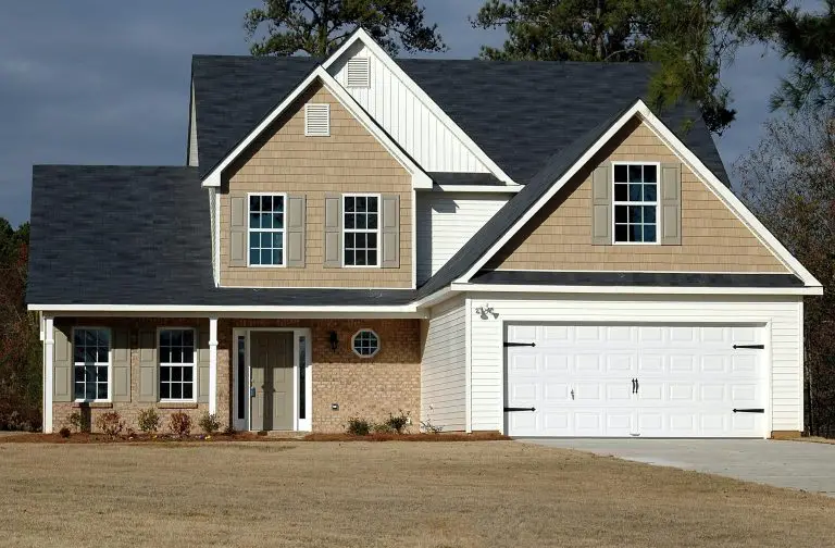 Modern suburban house with garage and front lawn.