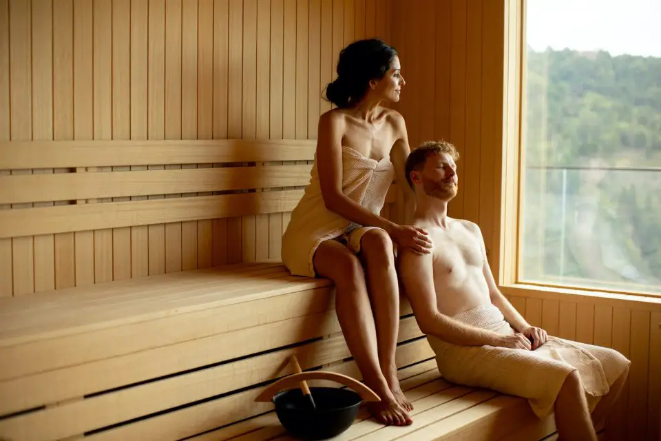 Two people relaxing in a sauna.