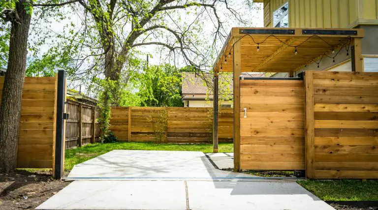 Modern backyard patio with wooden privacy fence
