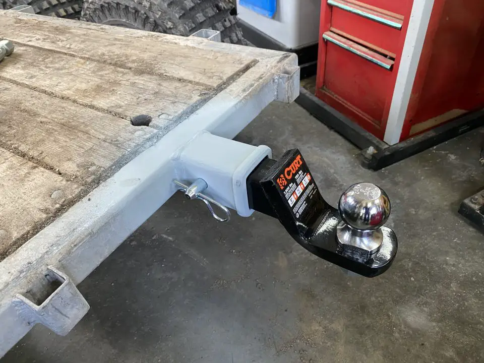 Trailer hitch attached to a wooden flatbed