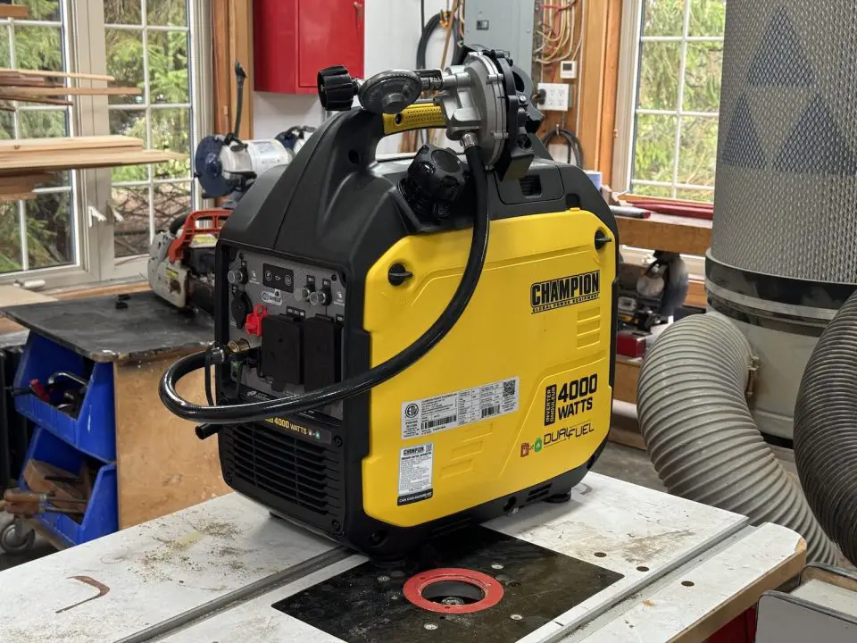 Yellow dual-fuel generator in workshop setting.