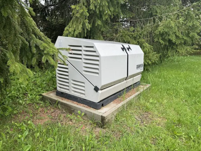 Outdoor home generator among trees and grass