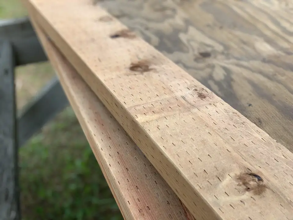 Close-up of seasoned wooden table surface.