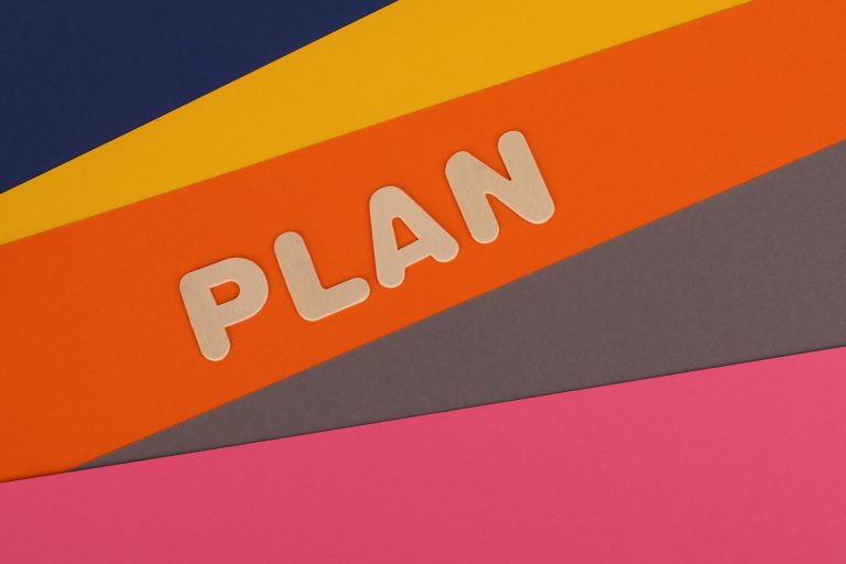 Colourful paper layers with word 'Plan' in letters